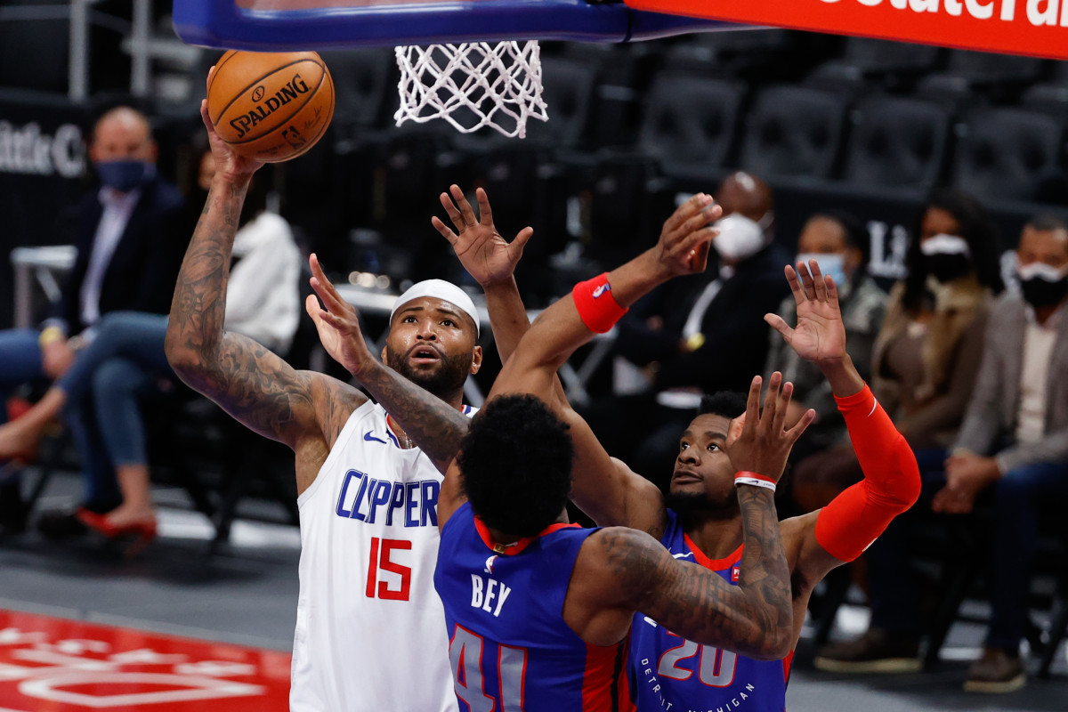 Apr 14, 2021; Detroit, Michigan, USA; LA Clippers center DeMarcus Cousins (15) shoots on Detroit Pistons forward Saddiq Bey (41) and guard Josh Jackson (20) in the second half at Little Caesars Arena. Mandatory Credit: Rick Osentoski-USA TODAY Sports